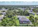 Aerial view showcases the home's screened-in pool, lanai, backyard, and neighborhood surroundings at 1269 N Lavina St, North Port, FL 34286