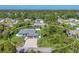 Aerial view highlights the home's front elevation, driveway, landscaping, and serene neighborhood setting at 1269 N Lavina St, North Port, FL 34286