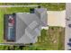 Aerial view of a home showcasing a screened pool, lanai, spacious backyard, and driveway at 1269 N Lavina St, North Port, FL 34286