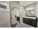 Modern bathroom with dual vanities, large mirror, and walk-in shower at 1269 N Lavina St, North Port, FL 34286