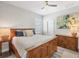 Well-lit bedroom with wood furnishings, ceiling fan, and calming wall art providing a relaxing space at 1269 N Lavina St, North Port, FL 34286