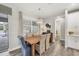 Dining room with wood table, wicker chairs, and plantation shutters at 1269 N Lavina St, North Port, FL 34286