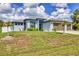 Charming home featuring a manicured lawn and an attached three-car garage at 1269 N Lavina St, North Port, FL 34286