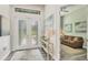 Bright foyer with a decorative console table and view into the living room at 1269 N Lavina St, North Port, FL 34286