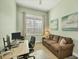 Study with comfortable seating, bright window and ample workspace at 1269 N Lavina St, North Port, FL 34286