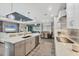 Bright, open kitchen with quartz counters and stainless steel appliances and view to Gathering room at 1269 N Lavina St, North Port, FL 34286