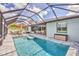 Beautiful screened-in pool complemented by a fully equipped outdoor kitchen and inviting lounge area at 1269 N Lavina St, North Port, FL 34286