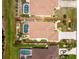 Overhead view of a well-maintained home featuring a large in-ground pool, lush landscaping, and a private backyard at 127 Jennifer Dr, Rotonda West, FL 33947