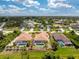 Aerial view of a single-Gathering home featuring a pool, screened lanai, and a well-maintained fenced backyard at 127 Jennifer Dr, Rotonda West, FL 33947