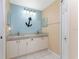 Bathroom featuring double sinks, granite countertops, and decorative accents at 127 Jennifer Dr, Rotonda West, FL 33947