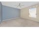 Spacious bedroom with neutral carpet, ceiling fan, and natural light at 127 Jennifer Dr, Rotonda West, FL 33947