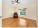 Bedroom with a ceiling fan, wood flooring, and a view to the exterior at 127 Jennifer Dr, Rotonda West, FL 33947