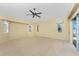 Bedroom with ample natural light, a ceiling fan, and a sliding glass door with access to the outdoors at 127 Jennifer Dr, Rotonda West, FL 33947