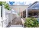 Exterior view of the home's covered walkway, with a white pergola and adjacent pool area, blending indoor and outdoor spaces at 127 Jennifer Dr, Rotonda West, FL 33947