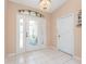 Bright foyer with tiled flooring, a decorative chandelier, and a coat closet at 127 Jennifer Dr, Rotonda West, FL 33947