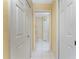 Hallway with tile flooring, multiple closets, and access to additional rooms at 127 Jennifer Dr, Rotonda West, FL 33947