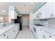 Bright kitchen with white cabinets, stainless steel appliances, and granite countertops at 127 Jennifer Dr, Rotonda West, FL 33947