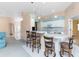 Open kitchen with bar seating, pendant lights, and modern appliances at 127 Jennifer Dr, Rotonda West, FL 33947