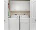 A laundry room featuring a washer, dryer, and upper cabinets for storage at 127 Jennifer Dr, Rotonda West, FL 33947