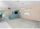 Spacious living room featuring plush carpeting, ceiling fan, and a sliding glass door to the pool area at 127 Jennifer Dr, Rotonda West, FL 33947
