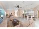 Open-concept living area with a ceiling fan, breakfast bar, and neutral color palette at 127 Jennifer Dr, Rotonda West, FL 33947