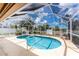 Sparkling pool surrounded by a screened enclosure and lush landscaping at 127 Jennifer Dr, Rotonda West, FL 33947