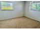 Bedroom with large windows and wall to wall carpeting at 133 Paddington Rd, Venice, FL 34293