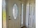 Elegant front door with decorative glass detailing and sidelights at 133 Paddington Rd, Venice, FL 34293