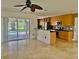 Open-concept kitchen with modern appliances and a breakfast bar overlooking the pool at 133 Paddington Rd, Venice, FL 34293