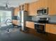 Modern kitchen featuring stainless steel appliances and a granite countertop island at 133 Paddington Rd, Venice, FL 34293