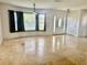 Bright living area with tile floors, large windows, and an decorative front door at 133 Paddington Rd, Venice, FL 34293
