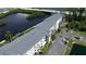 Scenic aerial view of a waterfront condo building with lush landscaping and parking area at 1401 S Mccall Rd # 101, Englewood, FL 34223