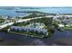 Aerial shot of a condo community featuring a pool, tennis court, and access to the water at 1401 S Mccall Rd # 101, Englewood, FL 34223