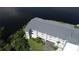 Aerial view of the condo building situated on the river, showcasing serene waterfront living at 1401 S Mccall Rd # 101, Englewood, FL 34223