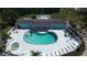Aerial view of the community pool with an attached spa, surrounded by palm trees and lounge chairs with lush landscaping at 1401 S Mccall Rd # 101, Englewood, FL 34223