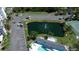 Aerial view of the community pond and parking spots with mature trees and lush landscaping at 1401 S Mccall Rd # 101, Englewood, FL 34223