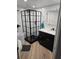 Modern bathroom with a sleek black-framed shower, stylish vanity, and updated fixtures at 1401 S Mccall Rd # 101, Englewood, FL 34223