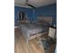 Comfortable bedroom with wood-style flooring, neutral furniture, and plenty of natural light at 1401 S Mccall Rd # 101, Englewood, FL 34223