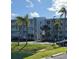 Exterior view of the condo building, highlighting the balconies and surrounding landscaping at 1401 S Mccall Rd # 101, Englewood, FL 34223