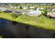 Aerial view showcases a waterfront property with a picturesque backyard and nearby golf course at 15 Bunker Pl, Rotonda West, FL 33947