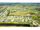 Aerial view of a home on the water, near a golf course with lush landscaping and community amenities at 15 Bunker Pl, Rotonda West, FL 33947