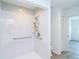A bright white shower with grab bars, handheld wand and a built-in toiletry shelf at 15 Bunker Pl, Rotonda West, FL 33947