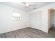 This bedroom features a closet, neutral walls, wood-look floors and a ceiling fan at 15 Bunker Pl, Rotonda West, FL 33947