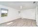 Bright bedroom features neutral walls, wood-look flooring, and a ceiling fan at 15 Bunker Pl, Rotonda West, FL 33947