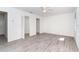 Large primary bedroom with gray floors, closet space, and two entry doors at 15 Bunker Pl, Rotonda West, FL 33947