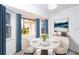 Bright dining area with white table set for three next to windows with serene outdoor views at 15 Bunker Pl, Rotonda West, FL 33947