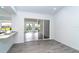 Dining room adjacent to a view of living area, featuring a breakfast bar and neutral paint at 15 Bunker Pl, Rotonda West, FL 33947