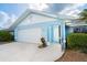 Exterior of a one-story home with a two car garage, featuring a well maintained lawn at 15 Bunker Pl, Rotonda West, FL 33947