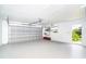 Spacious garage with an automatic door, ample storage, and an access door to the backyard at 15 Bunker Pl, Rotonda West, FL 33947