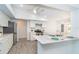 Stylish kitchen with stainless steel appliances, quartz counters, and gray flooring at 15 Bunker Pl, Rotonda West, FL 33947
